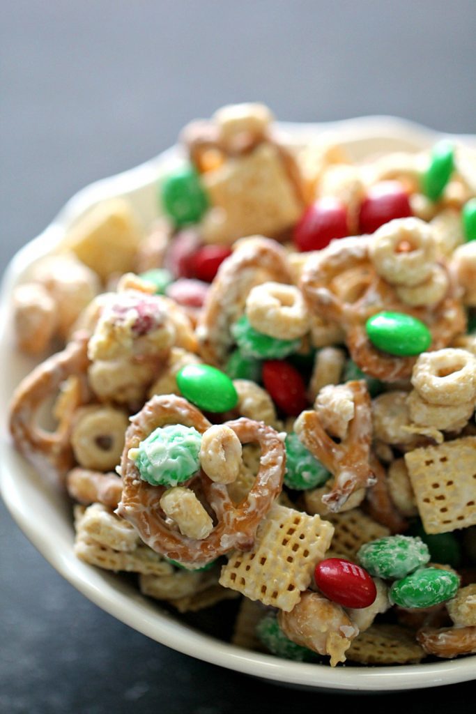bowl of Chex mix and M&Ms mixed in melted white chocolate